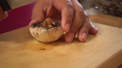 Close Up Slicing Mushroom on a Cutting Board