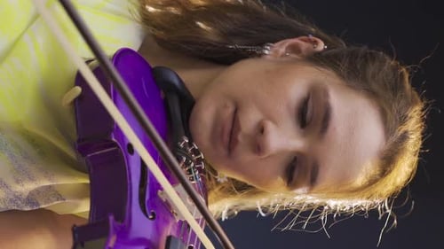 Woman Playing Electric Violin in Close Up