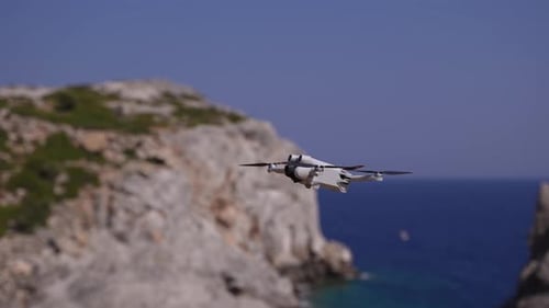 Drone Flying Above Rocky Coastline During Daytime