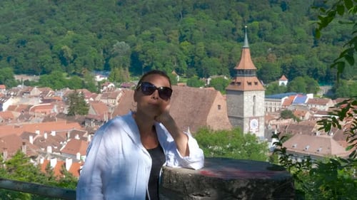Woman Poses in front of European City
