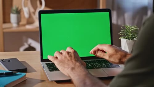 Hands Typing on Laptop with Green Screen