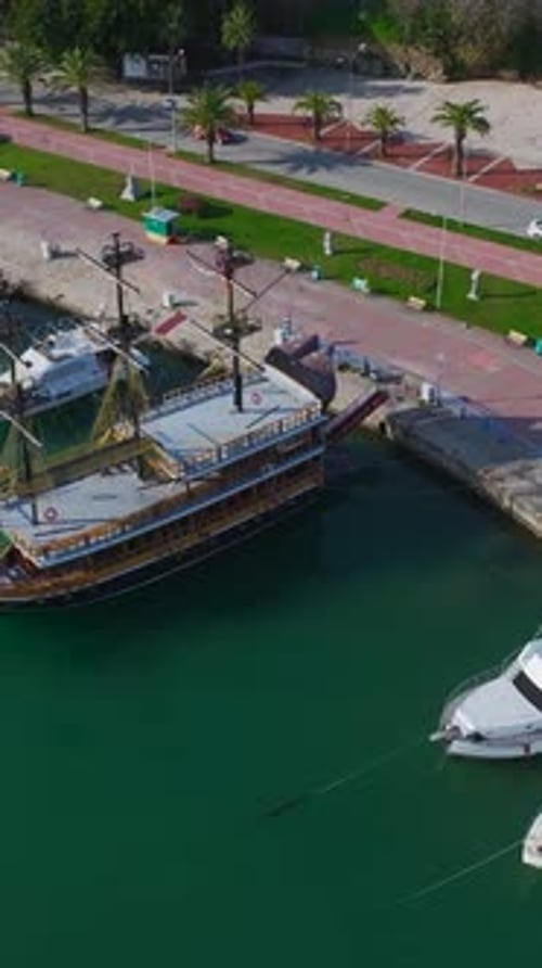 Vertical Video of a Tourist Port With Boats Lined Up at the Dock Captured From Above With a Perfect