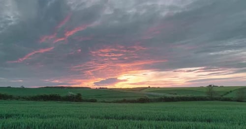 Sunset Time Lapse Over Green Field