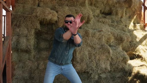 Man Expresses Joy in Rural Setting Playful Man Moment on Hay Concept of Playful Spirit