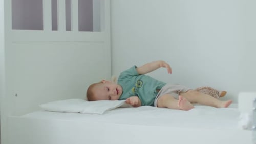 Blond Haired Baby Smiling in Crib