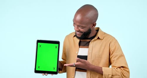 Tablet, green screen and a man in studio with mockup website, internet and social network