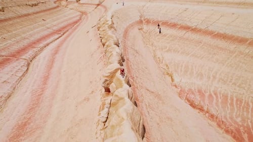 Aerial view of person walking ridge in desert