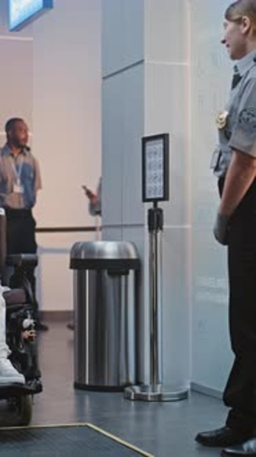 Security Checkpoint in Airport Terminal Female Security Officer Inspecting Woman in Wheelchair