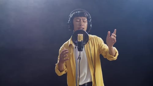 Young Adult Singing in Recording Studio Microphone