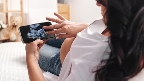 Pregnant Brunette Woman with Belly Looking x Ray Scan Diagnostic on Smartphone Waiting Baby