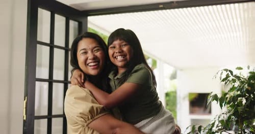 Smiling Woman Holding Child in Close Embrace Indoors