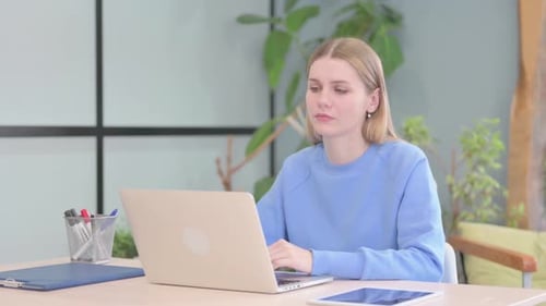 Surprised Young Woman Working on Computer