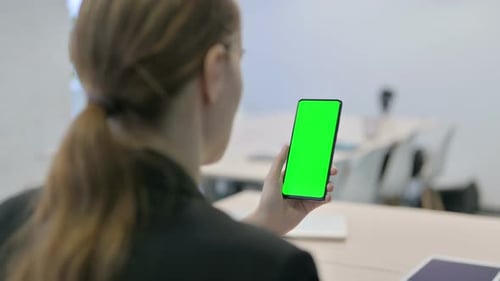 Businesswoman Using Smartphone with Green Screen