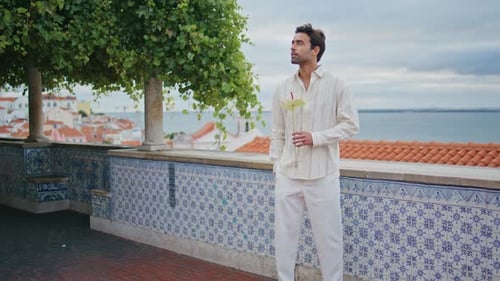 Man in Suit Stands by Scenic Ocean View