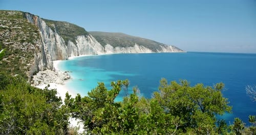 Beautiful Fteri beach on Keflaonia Island, Greece. White rocks and blue lagoon surrounded by green f