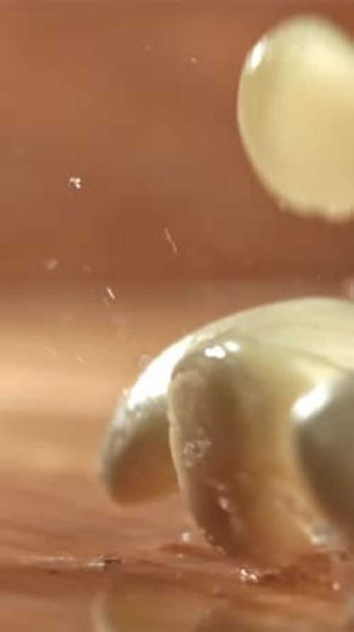 Fresh Garlic Falls on a Wet Cutting Board Filmed on a Highspeed Camera at 1000 Fps