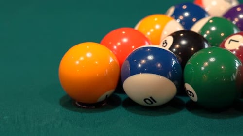 Person Breaks Pool Balls on 8 Ball Triangle Rack Closeup on the Spot with Solid and Stripped Billiar
