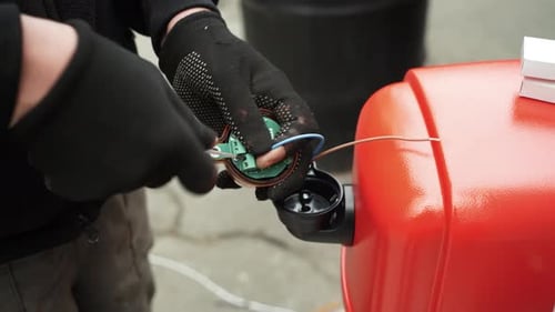 Electrician connects the yellow Signal Lamp for the gate. Warning yellow flash lamp