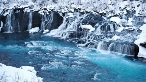 Waterfall in Iceland Snowy Mountain and Pure Blue Glacier River in Winter