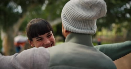 Friends Embrace in Sunny Urban Park
