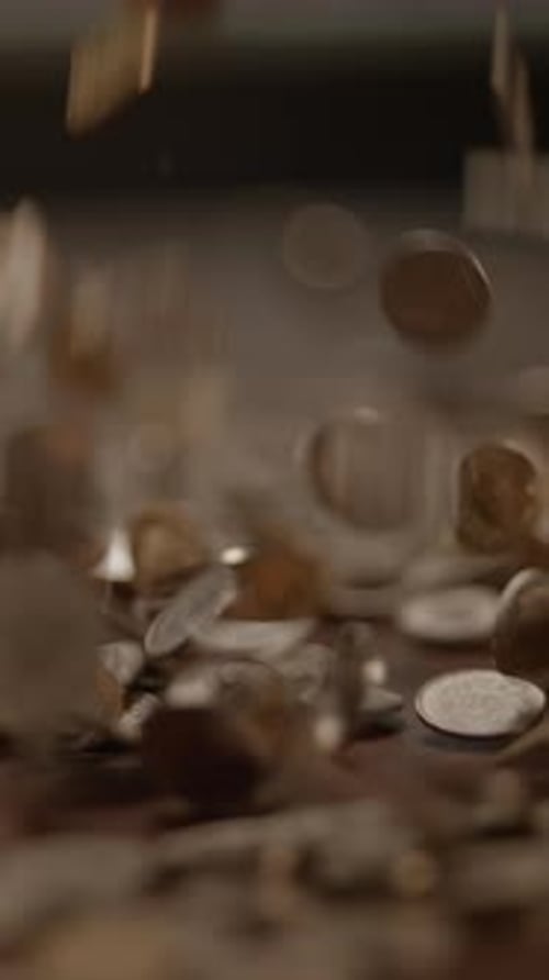 The Sound and Sight of Falling Coins on a Surface Illustrating Financial Transactions and Wealth