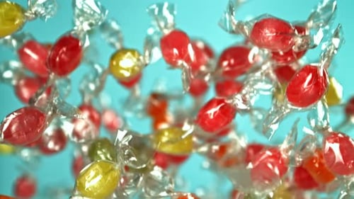 Colorful Wrapped Candy Falling on a Blue Background