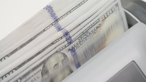 Money Counter Machine Counts Stacks of Hundred Dollar Bills