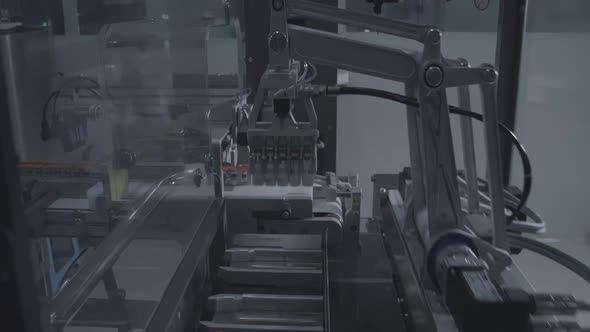 Automated vaccine vial on conveyor belt by modern robot hand, the ...