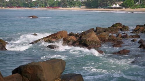 Ocean Waves Crash Onto Rocky Coast Tropical Beach Visible Rocks As Natural Barrier Waves Splash Over