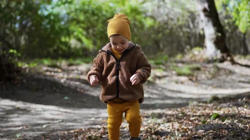 Cute Infant Walking on Path in the Woods