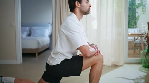 Man Stretching on Yoga Mat Indoors