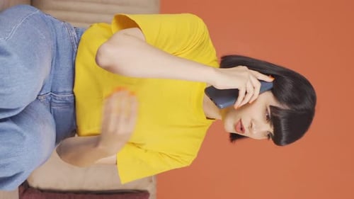 Woman Talking on Phone on Couch in Vertical Video