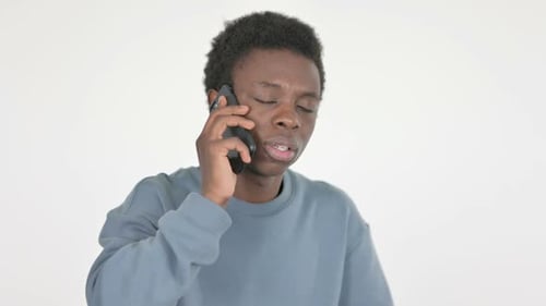 Young Adult Talking on Smartphone Against White Background