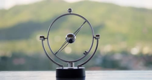 Rotating Table Pendulum Balls Anti Stress in the Tropical Nature Background at the Morning Video for