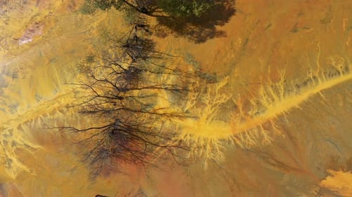 Flying over decanting lake. Colorful AMD acid mine drainage waters aerial view