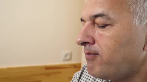 Man Eating Popcorn Indoors, Close Up Profile