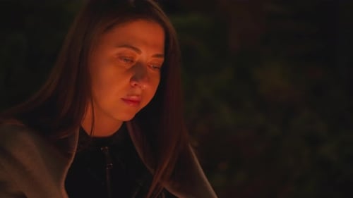 Young Woman Lit by Campfire at Night