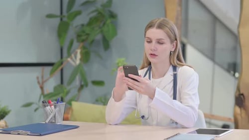 Doctor Browsing Smartphone in Clinic