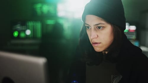 Focused Young Adult Works at Computer at Night