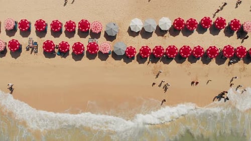 Top Aerial View on Sandy Ocean Shore with Resting Tourists and Beach Umbrellas Turquoise Water in