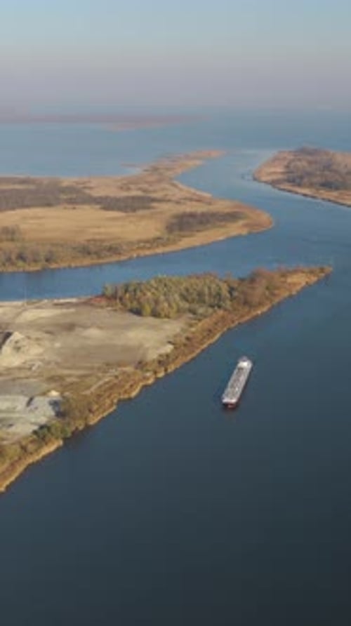 Global trade in motion as oil tanker navigates bustling waterways. Vertical video