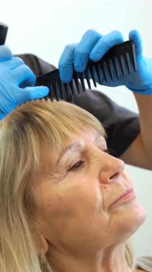 Medical Professional Treating Woman's Scalp