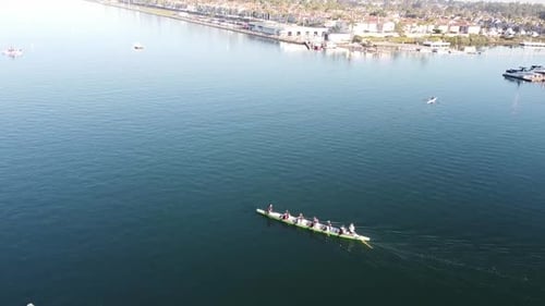 A dragon boat paddle across the water channel, aerial view.