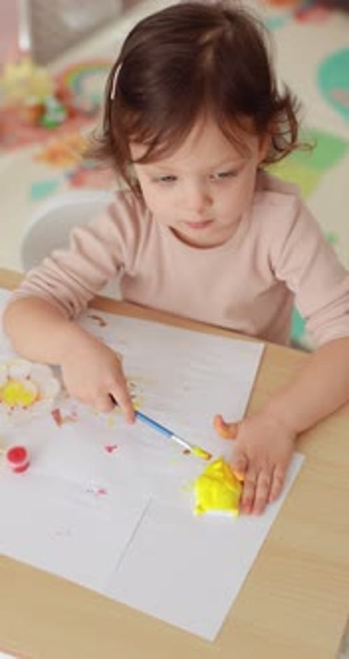 Child Painting Art Project at Table Indoors
