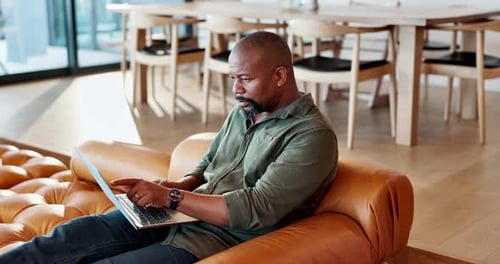 Adult Working on Laptop at Home