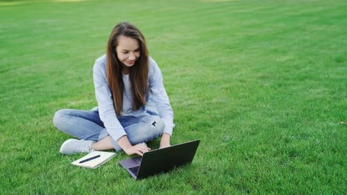 Woman Student Working on Laptop Computer in College Campus. Freelancer Professional Working