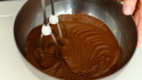 Mixing Chocolate Batter with Electric Mixer in Bowl
