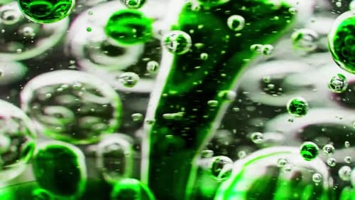 macro shot of a swirl with green bubbles in water