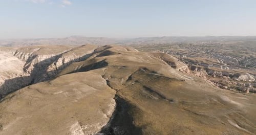 Aerial view of a landscape rugged mountains with deep valleys, Cappadocia, Turkiye
