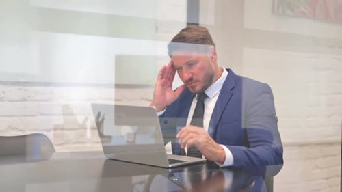 Man Uses Laptop in Modern Office Space